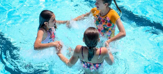 Three girls in the swimming pool.