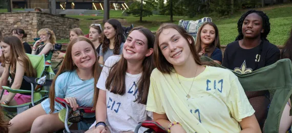 Campers gathered together at closing campfire