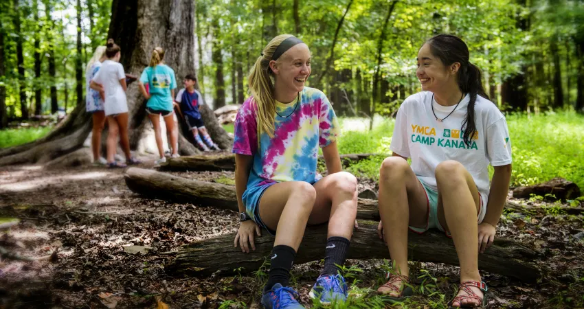 Two girls sitting under the Big Tree talking